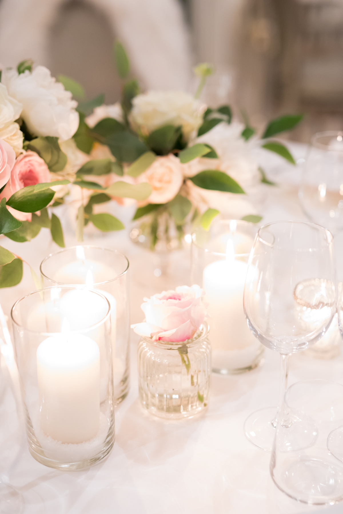 Elegant table setting with flowers, candles and wine glasses