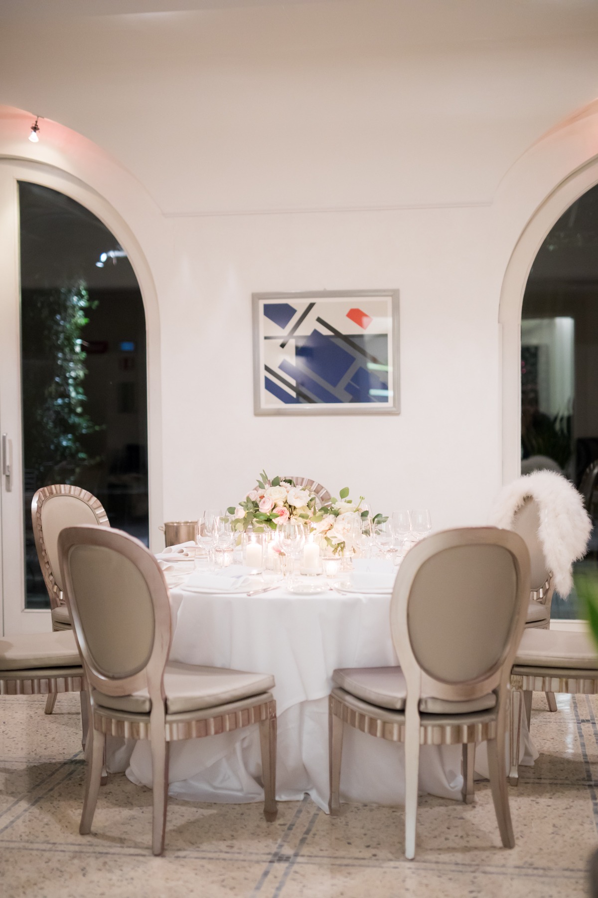 Elegant dining table setting with flowers and chairs