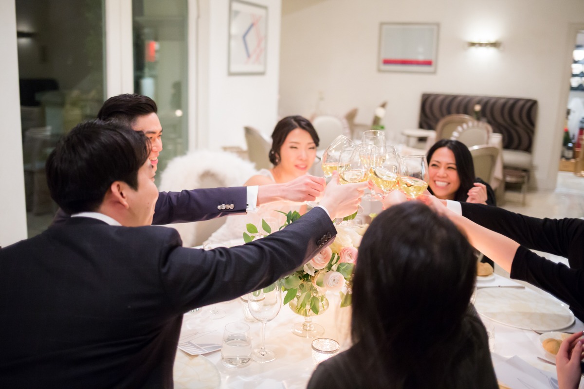 Friends raise glasses in a toast at a celebratory dinner party