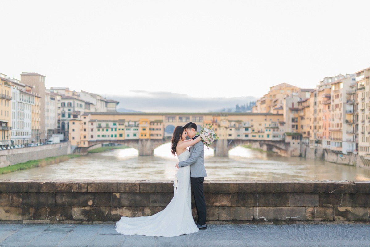 Newlyweds embrace in Florence Italy during their wedding photoshoot