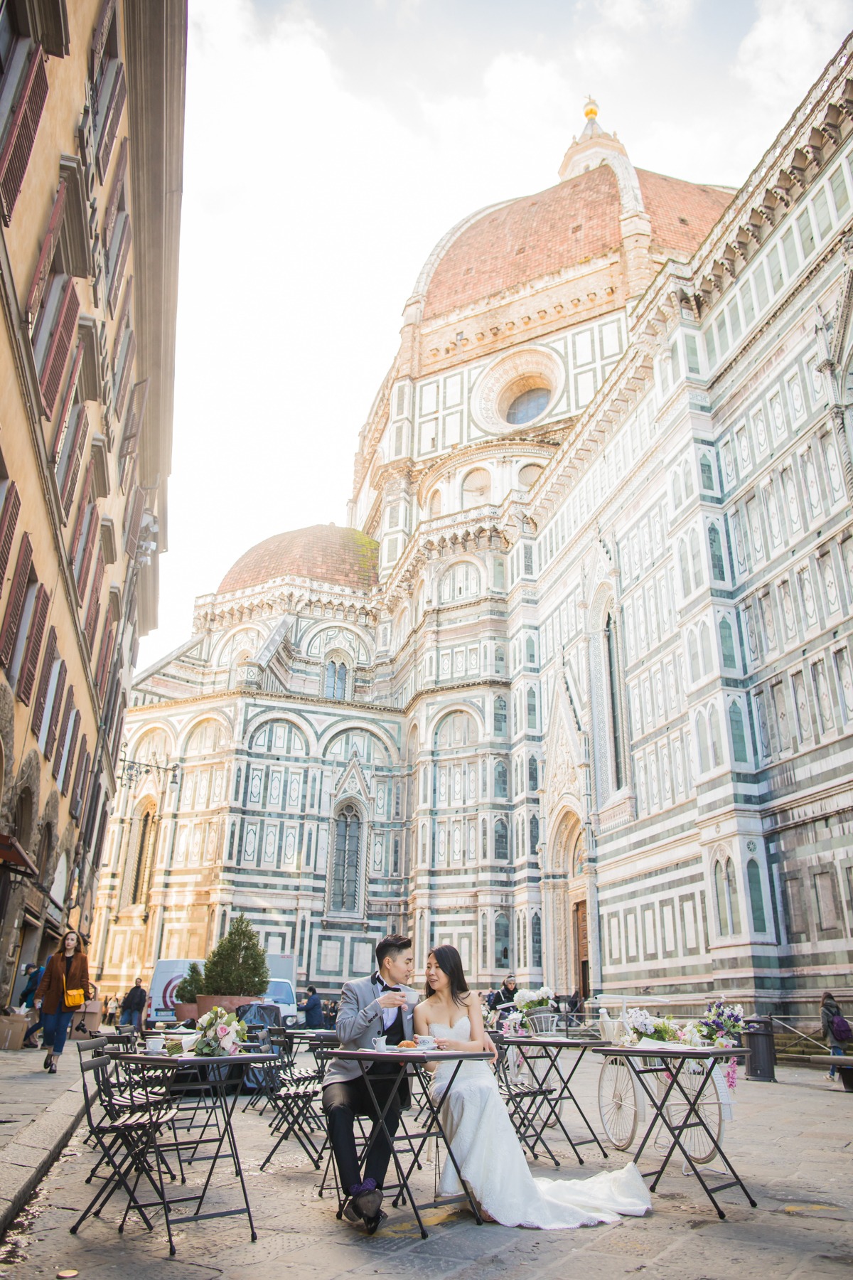 Couple enjoying coffee outside Florence Cathedral on their wedding day