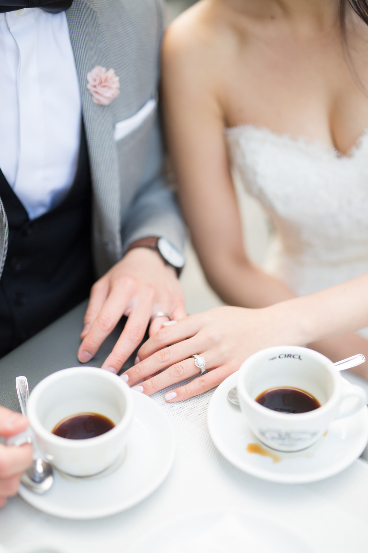Newlyweds enjoying coffee with rings on display, wedding day
