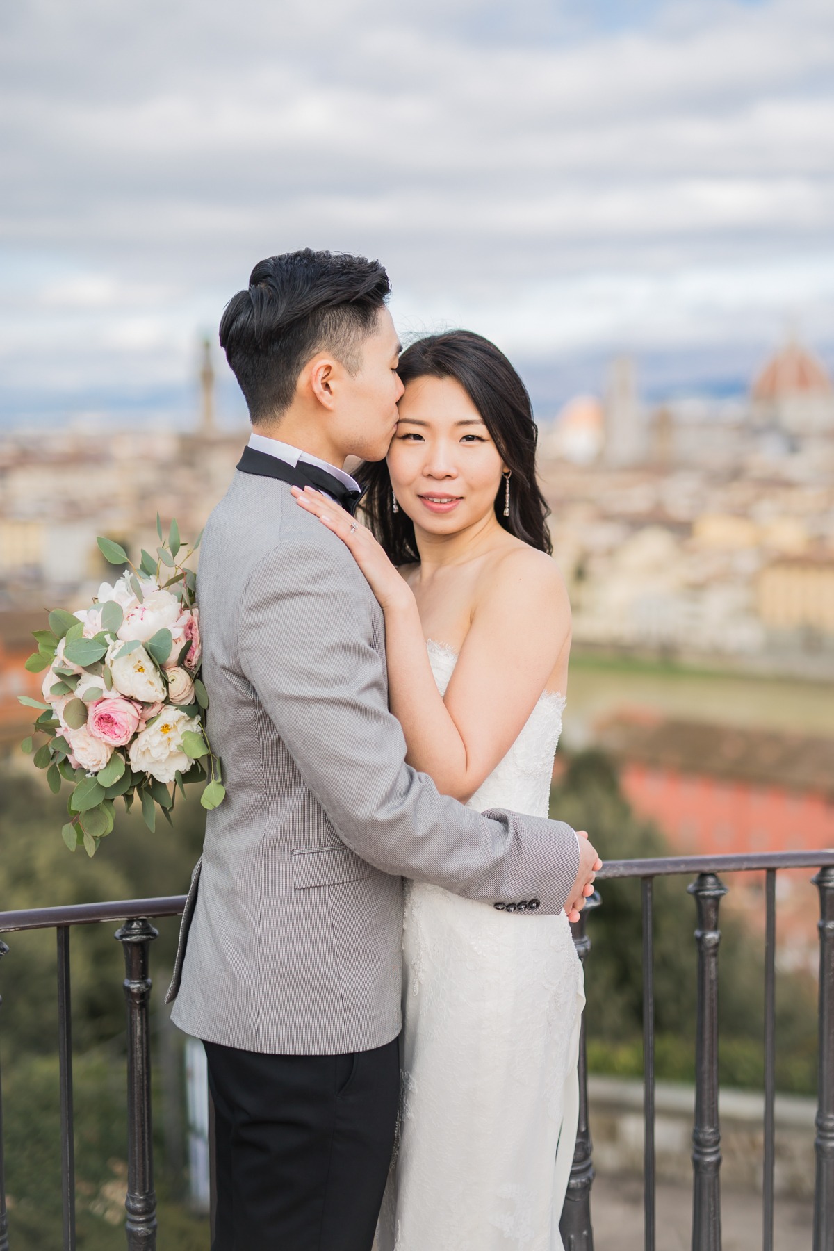 Romantic wedding couple embracing with beautiful cityscape