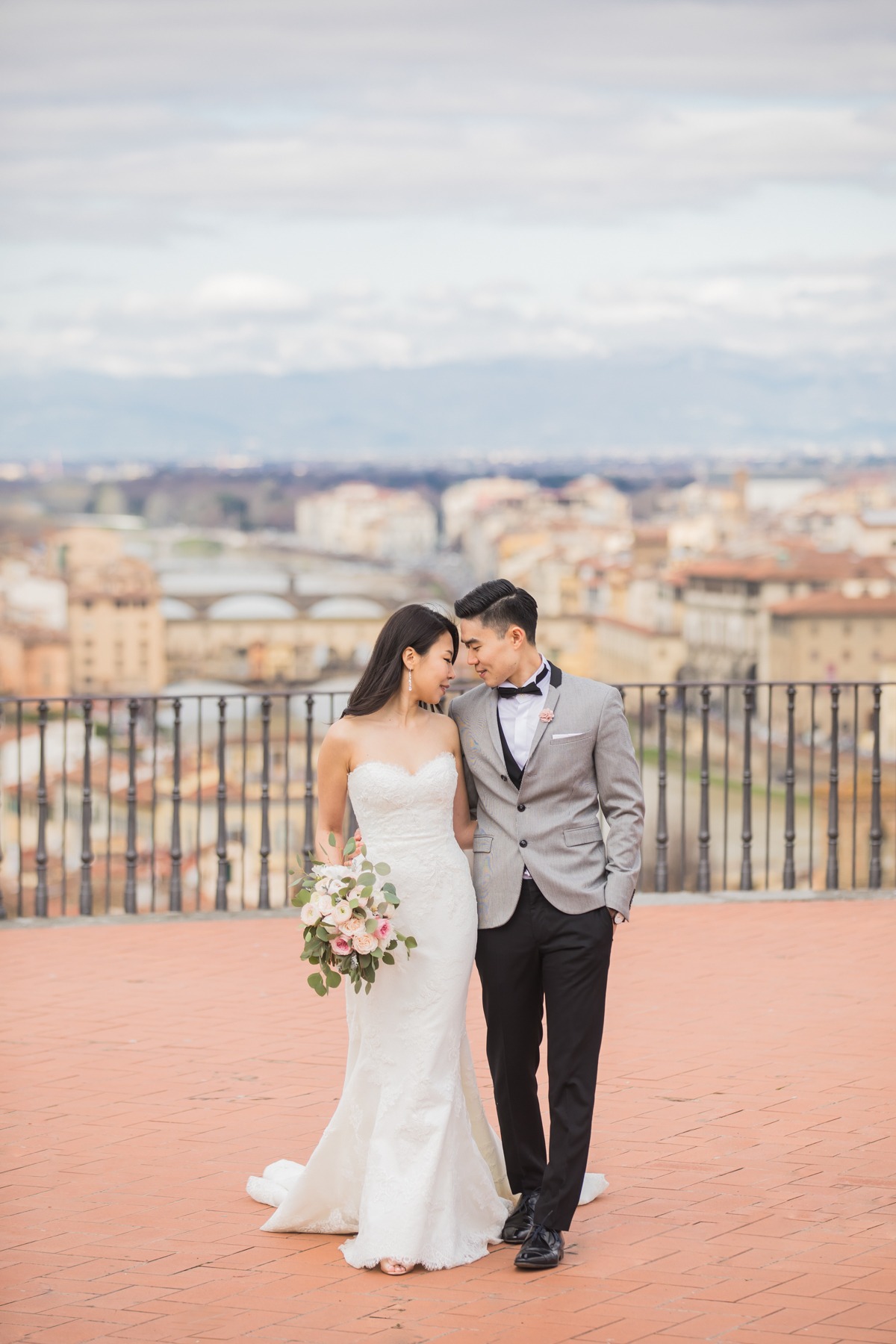 Elegant wedding couple overlooking cityscape, romantic moment