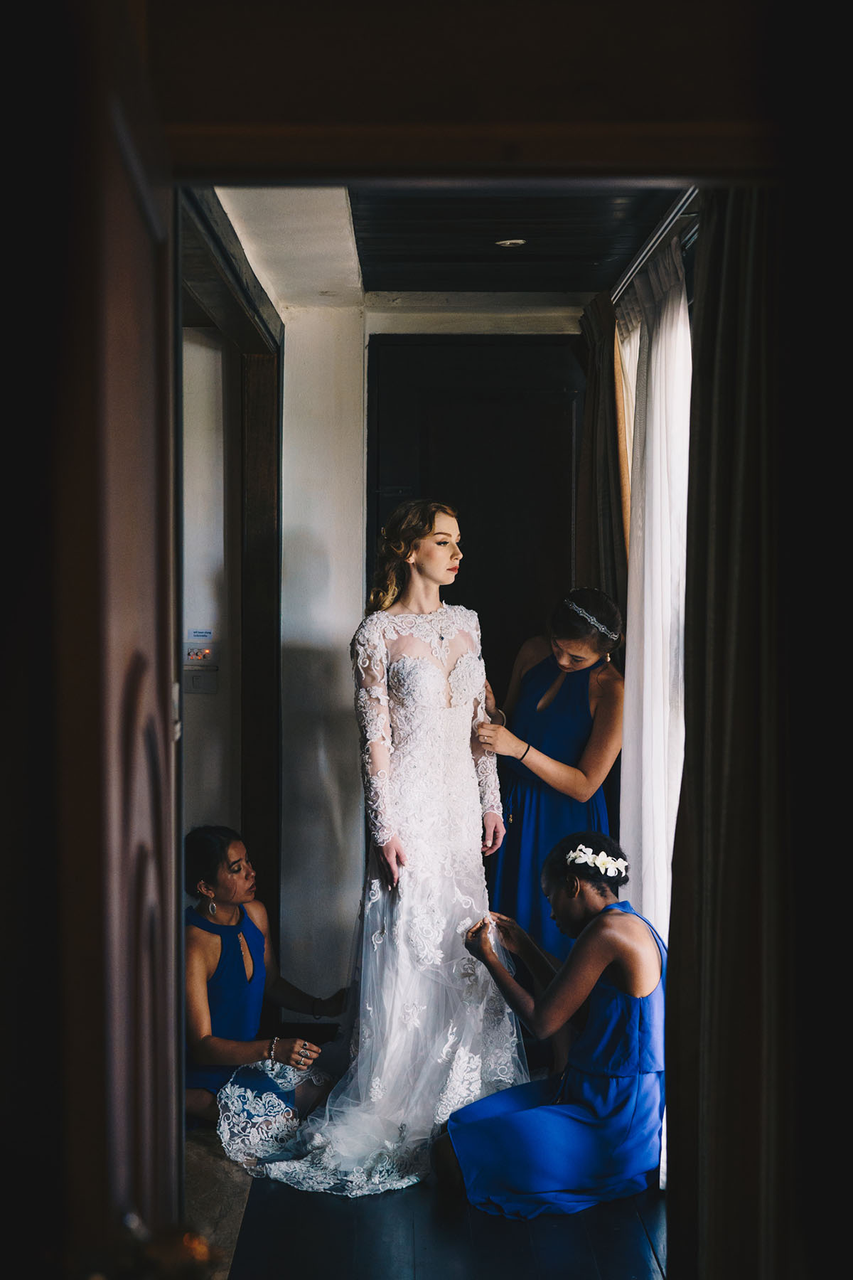 Bride with bridesmaids getting ready on wedding day