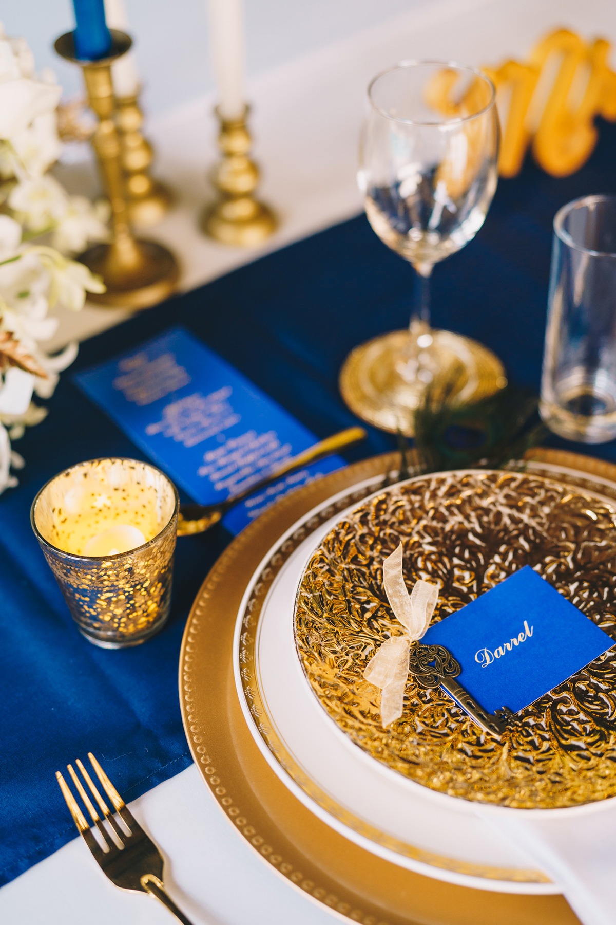 Elegant gold and blue table setting with place setting card