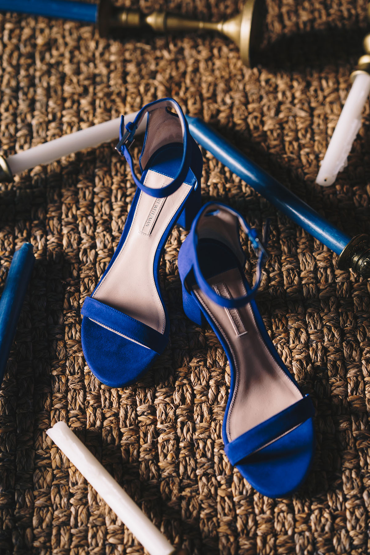Elegant blue sandals on a textured surface, a stylish detail