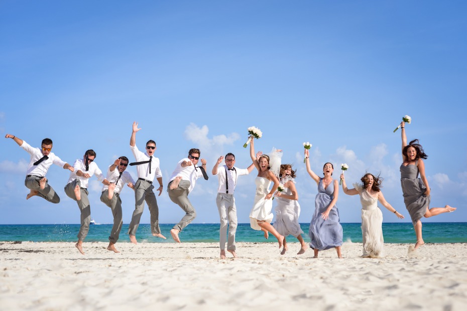 Palace Resorts destination wedding bridal party jumping on the beach