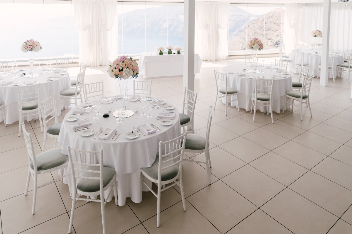 Elegant wedding reception setup with round tables and floral centerpieces