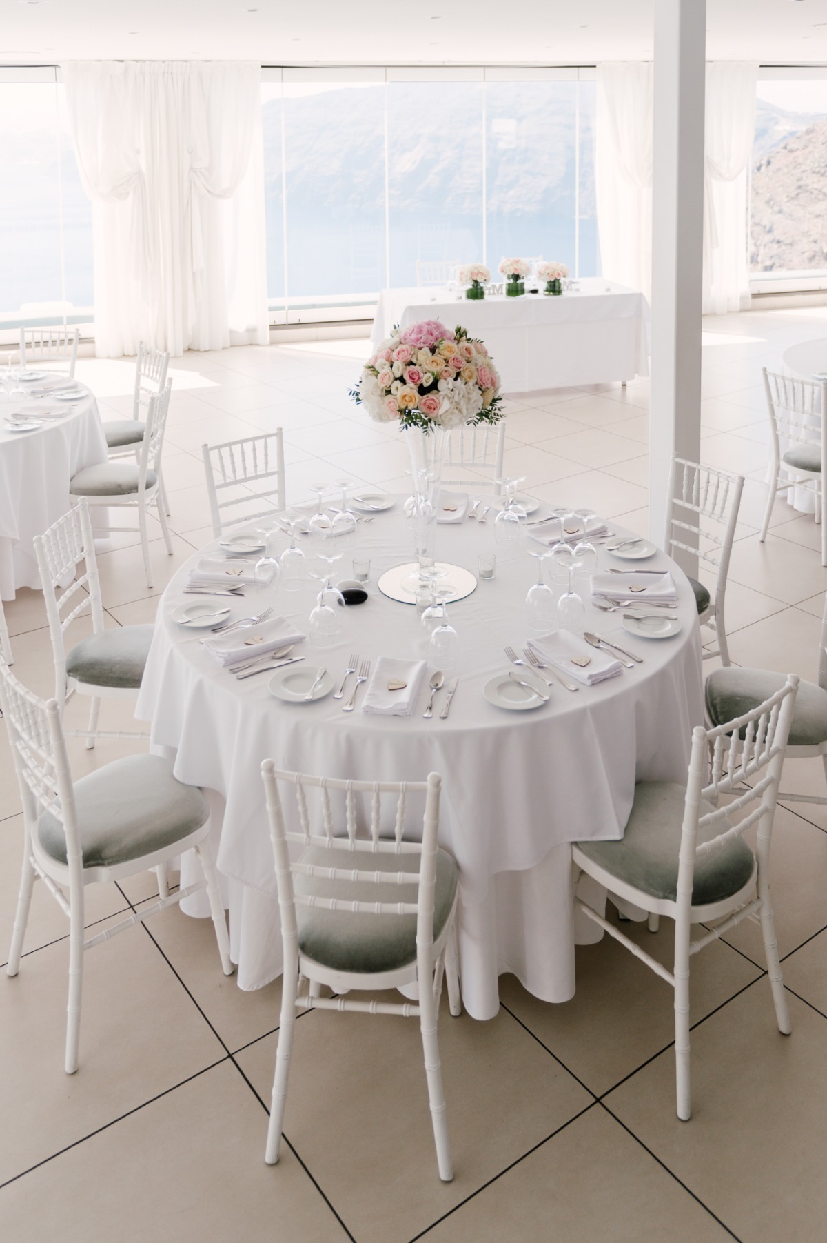 Elegant wedding reception setup with round tables and floral centerpiece