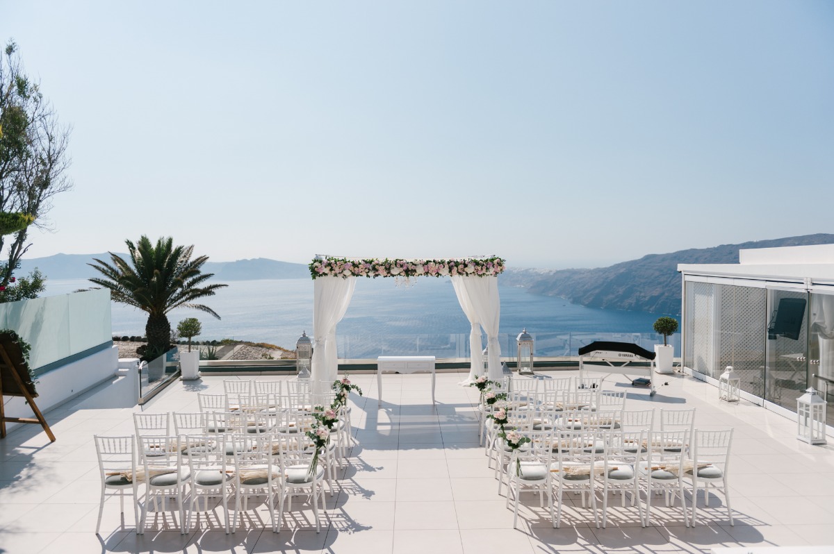Santorini wedding venue with ocean view and floral arch