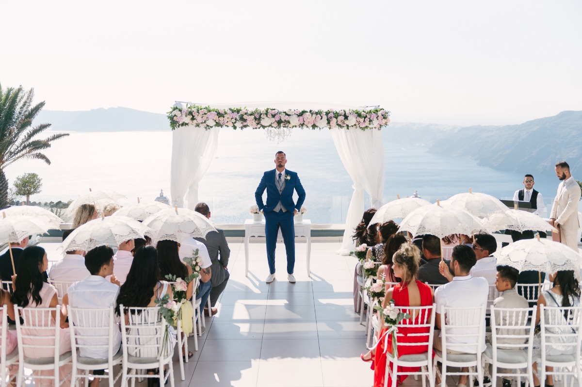 Santorini wedding groom awaits bride ceremony by sea