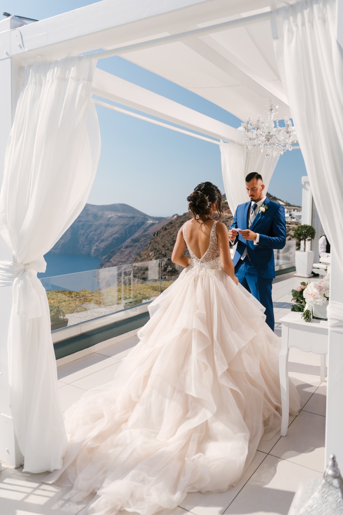 Bride and groom at an outdoor wedding ceremony in Santorini