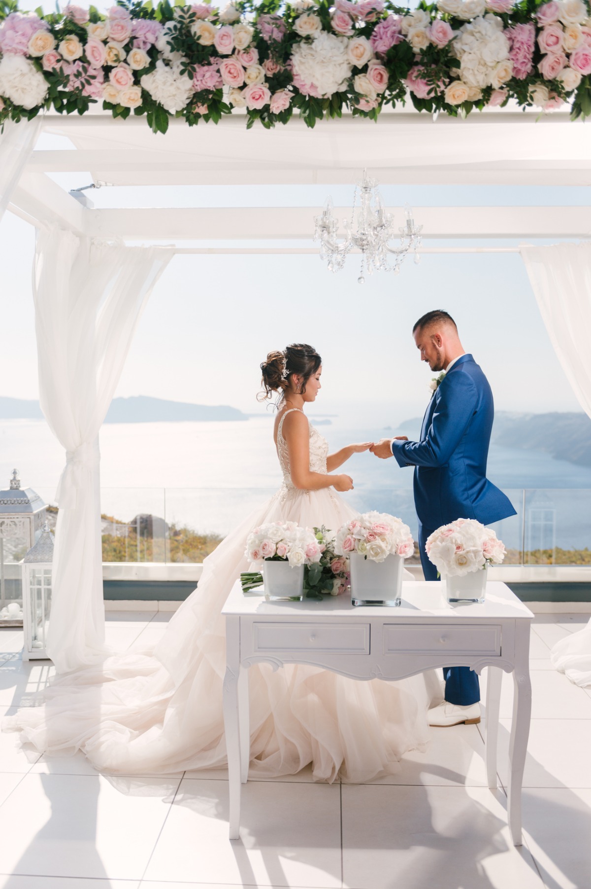 Bride and groom exchanging rings at outdoor wedding