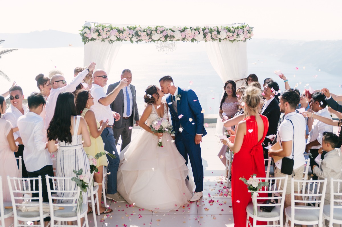 Bride and groom kissing at Santorini wedding ceremony