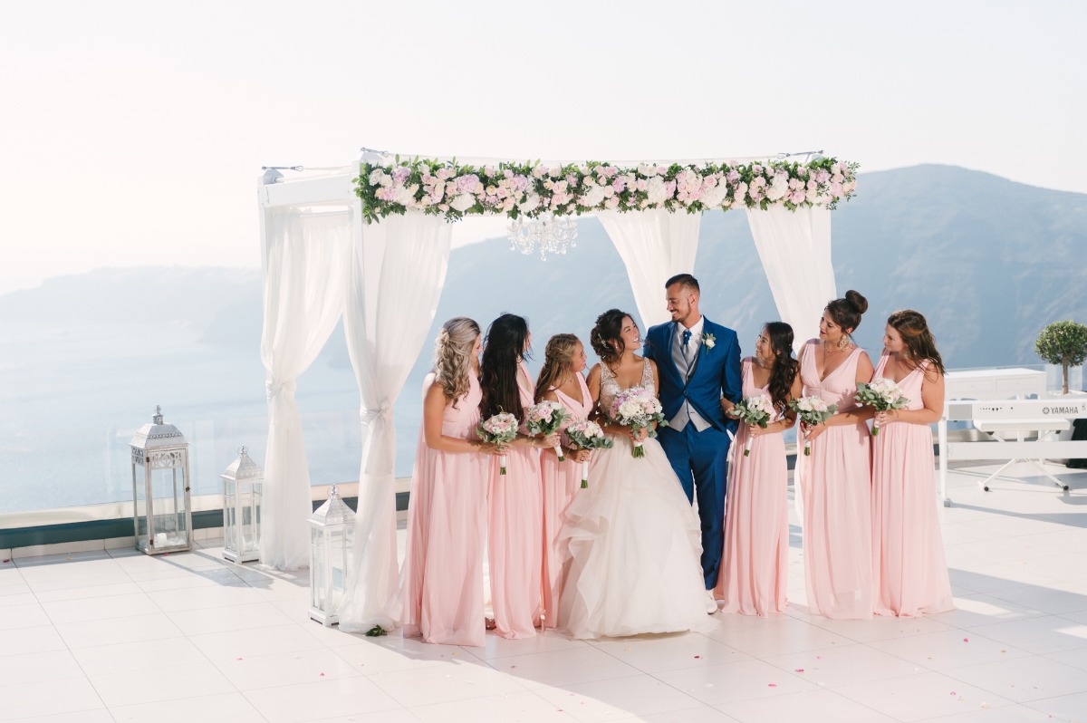 Bride groom and bridesmaids at outdoor Santorini wedding