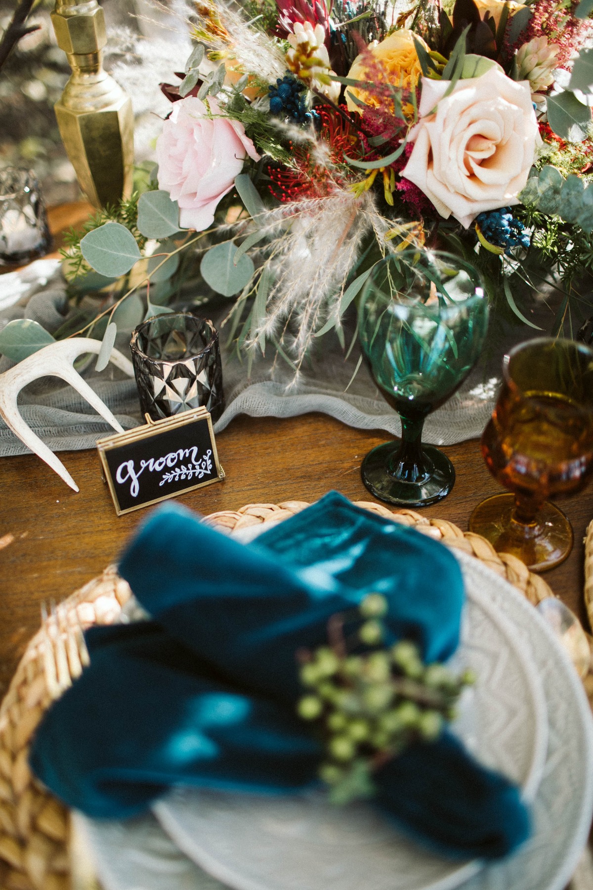 Elegant wedding table setting with flowers and groom sign