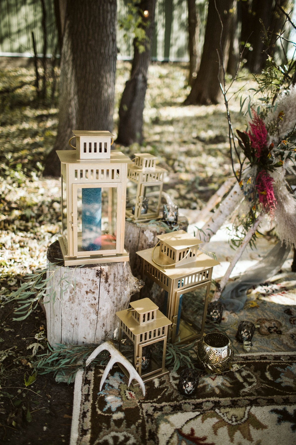 Rustic wedding decor with lanterns in a forest scene
