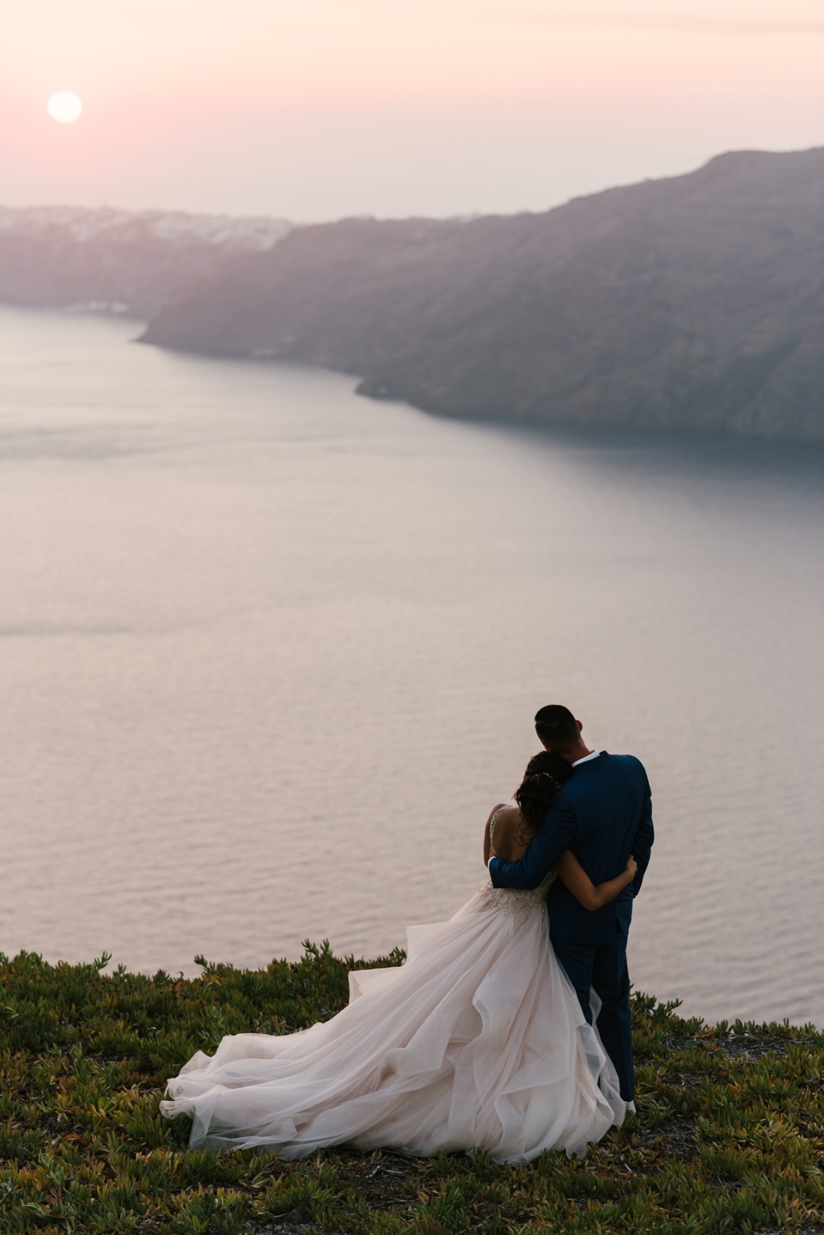 Bride and groom embrace at their Santorini wedding