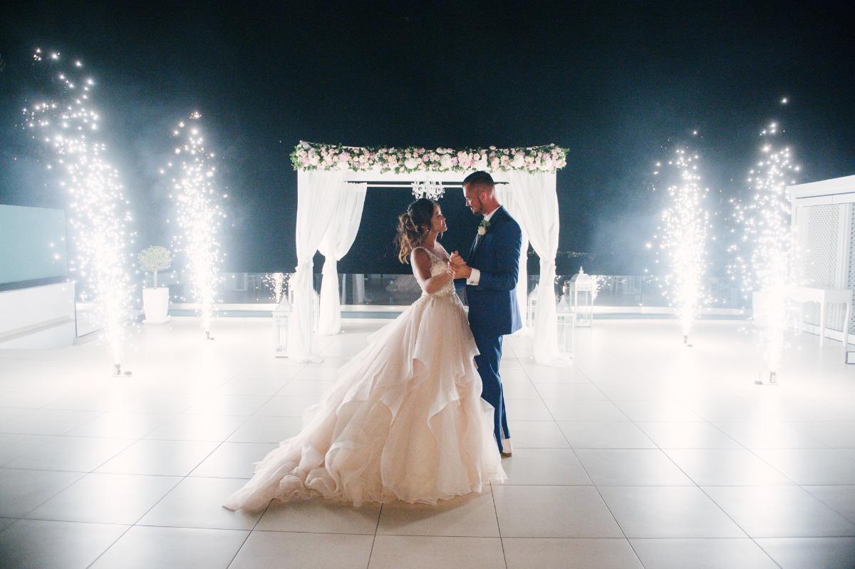 Newlyweds dance with fireworks at a dreamy wedding celebration