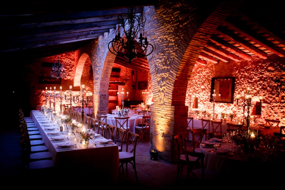 Romantic candlelit wedding venue with brick arches