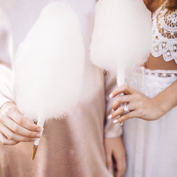 Bride and bridesmaid holding cotton candy