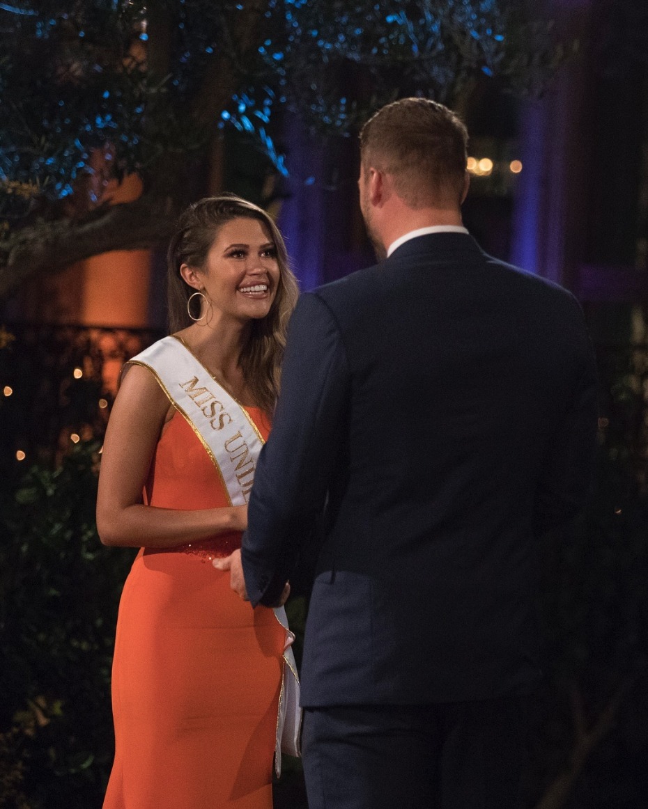 Smiling beauty queen smiles at man on outdoor date night