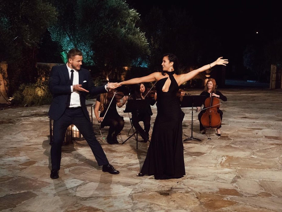 Joyful couple dances to string quartet music outdoors