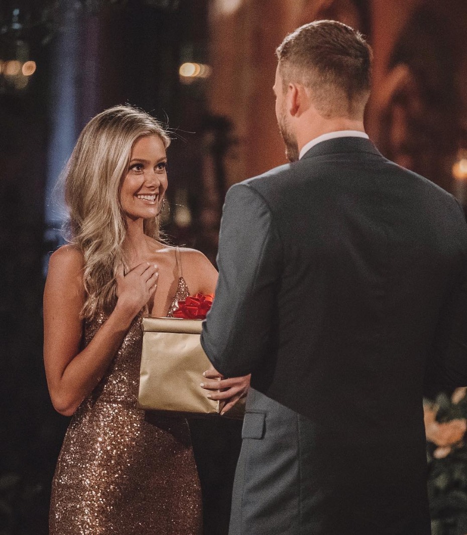 Woman in sparkling dress receives gift from man in suit