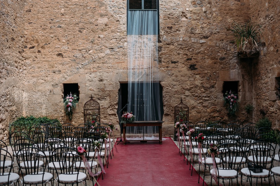 Outdoor wedding ceremony in rustic stone courtyard