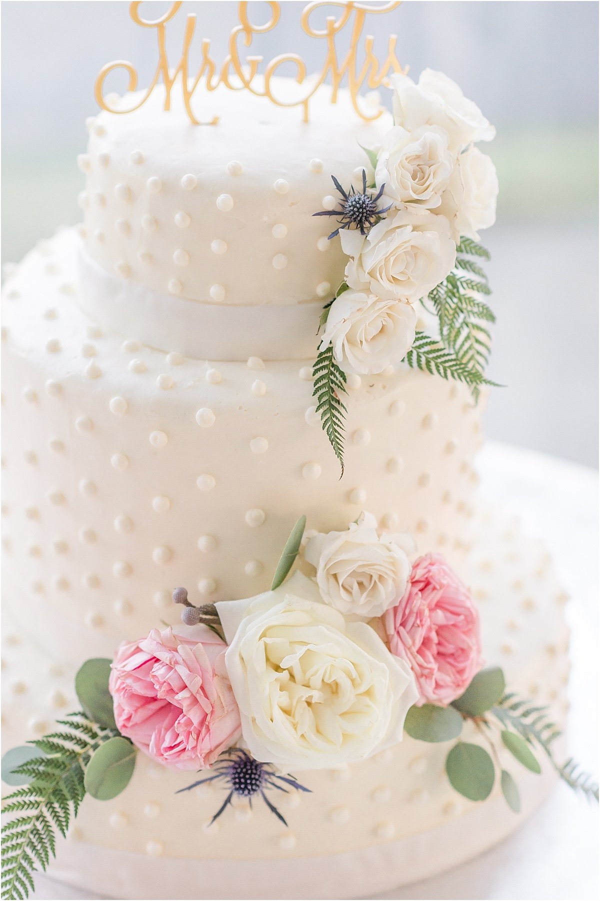 white and pink floral accented cake