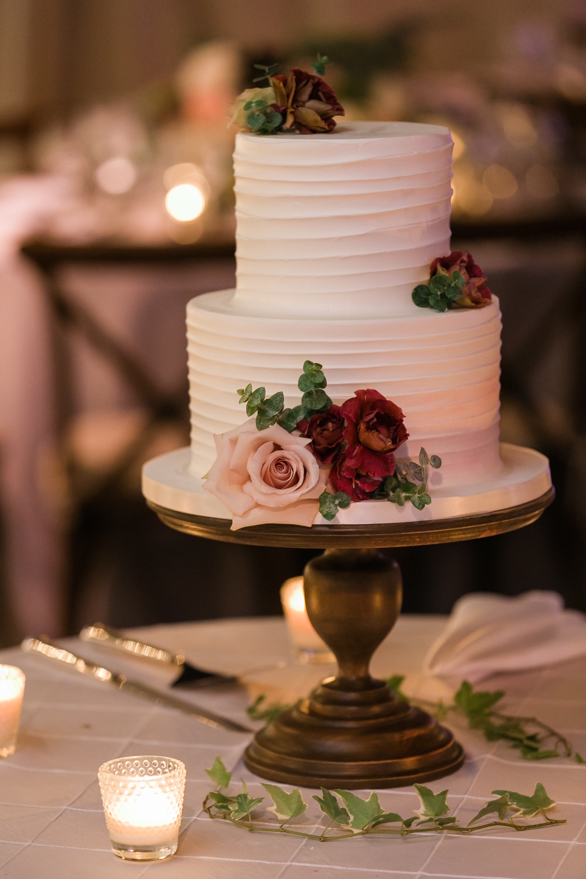 simple white wedding cake with floral accents