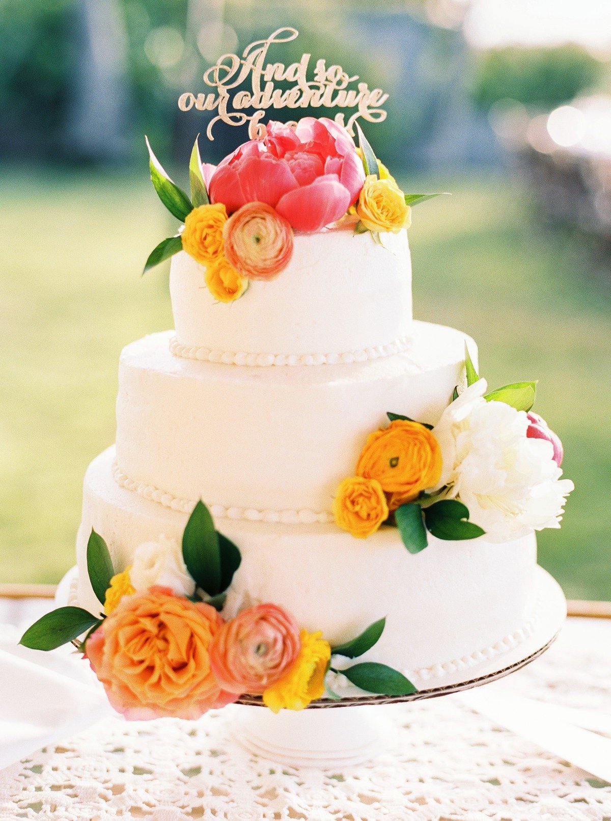 sunset inspired floral accented wedding cake
