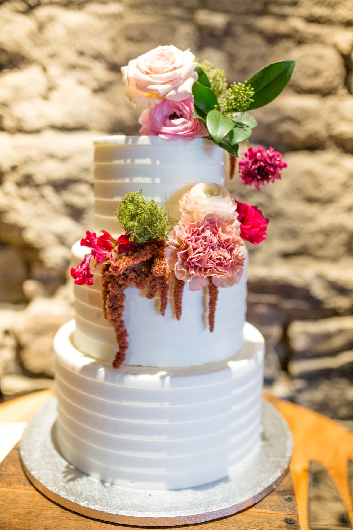 Three tier wedding cake with florals