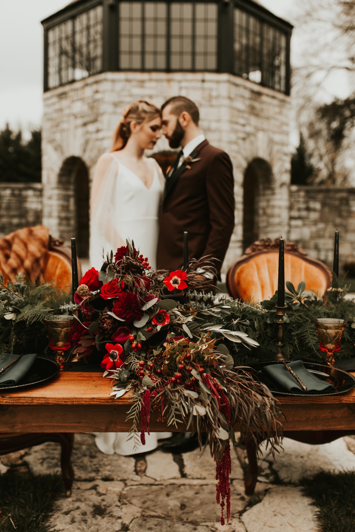 Romantic wedding portrait with red floral table decor