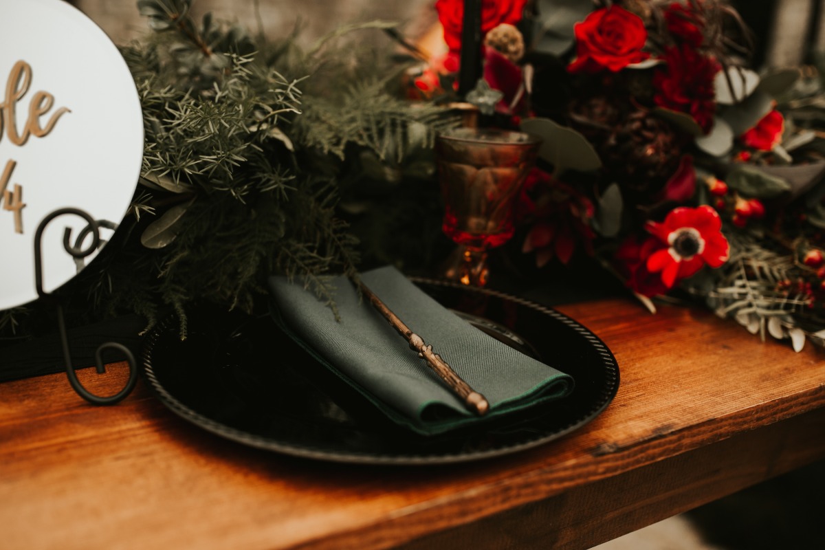 Elegant table setting with floral centerpiece and magic wand