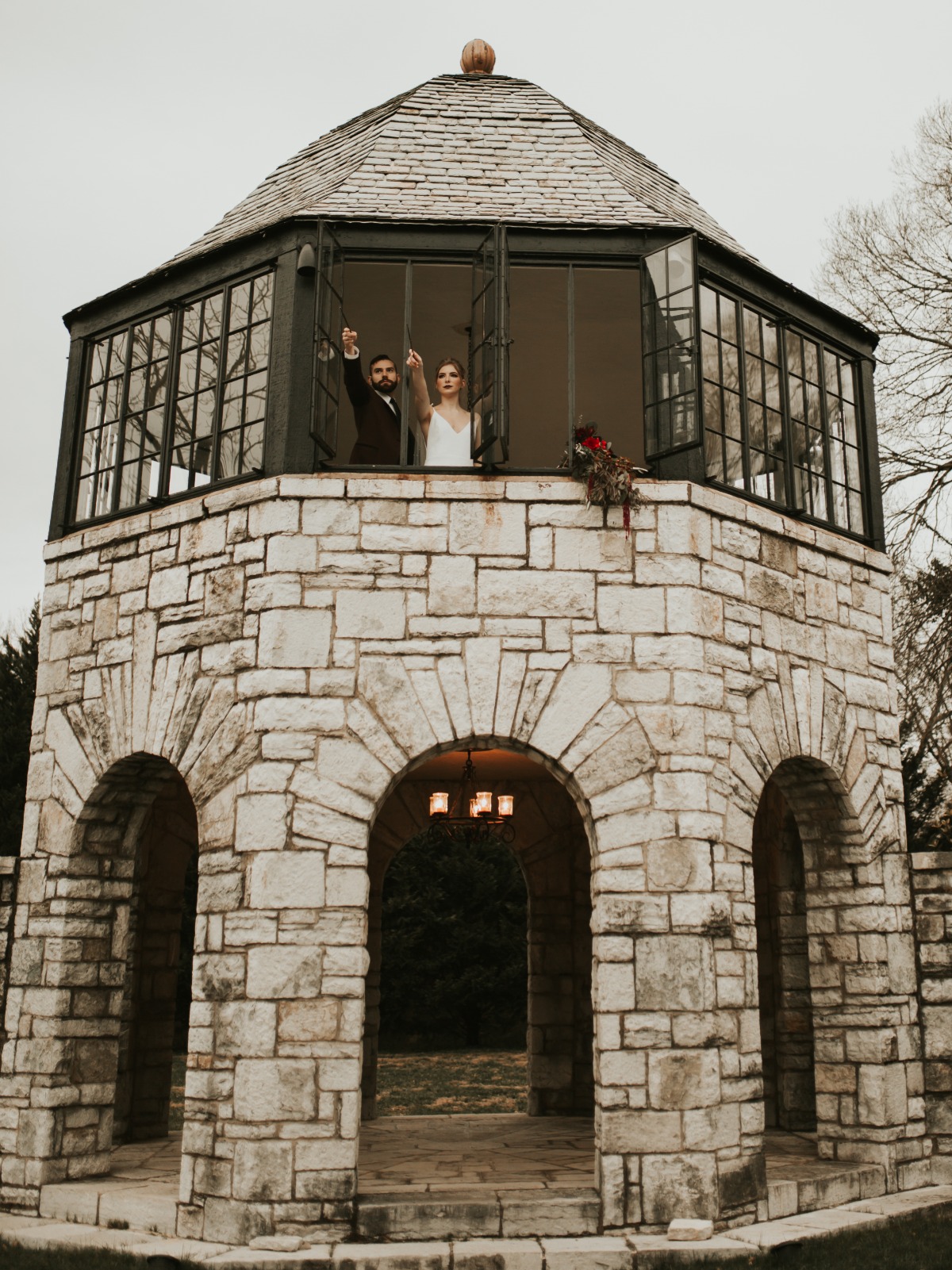 Newlyweds celebrate marriage in stone gazebo tower
