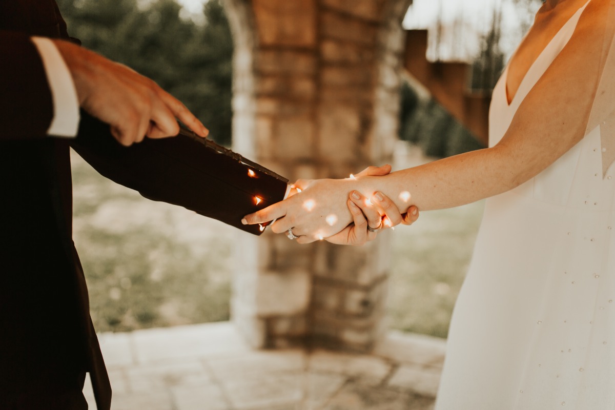 Bride and grooms hands intertwined on their wedding day