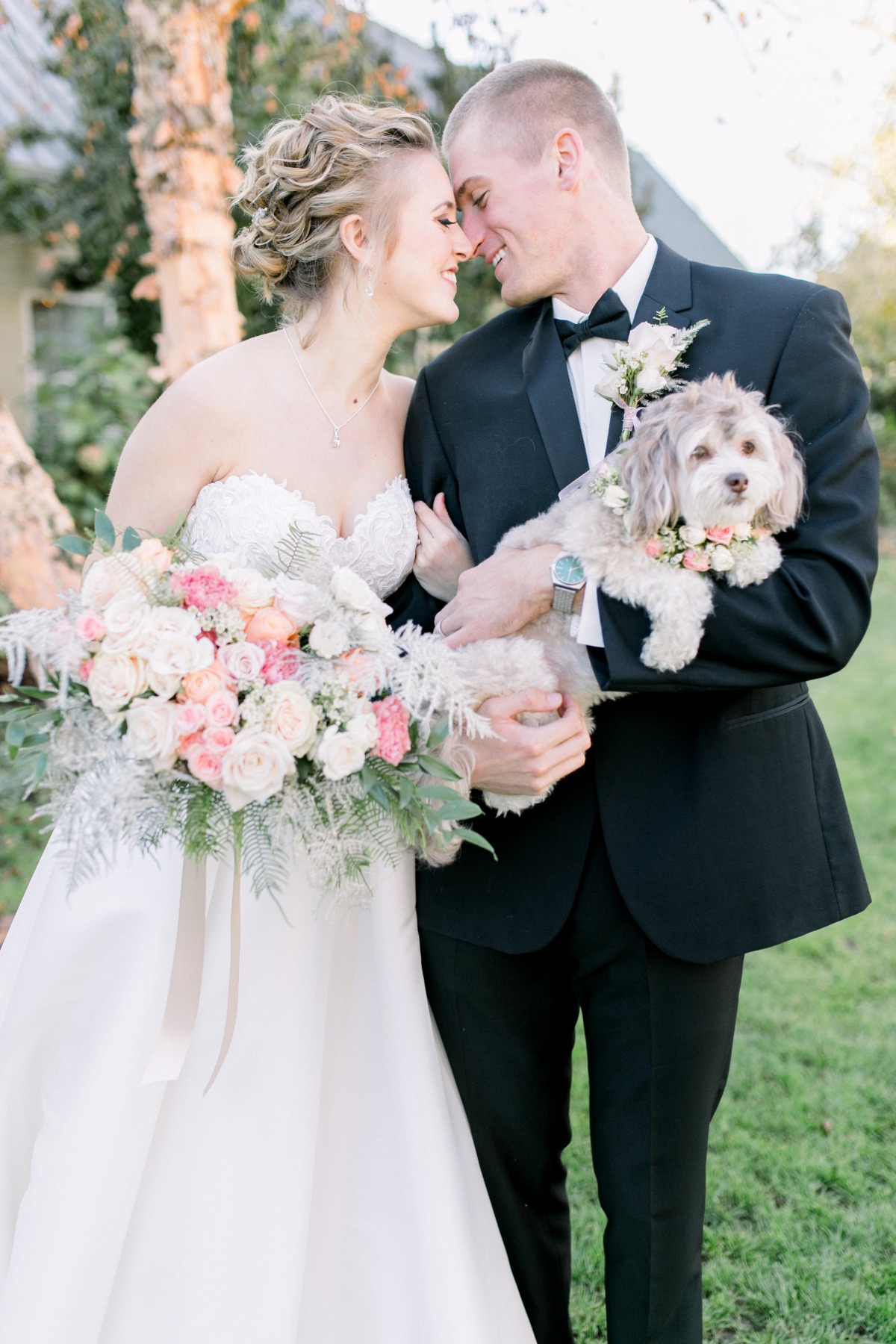 Happy couple with dog celebrate wedding day outdoors