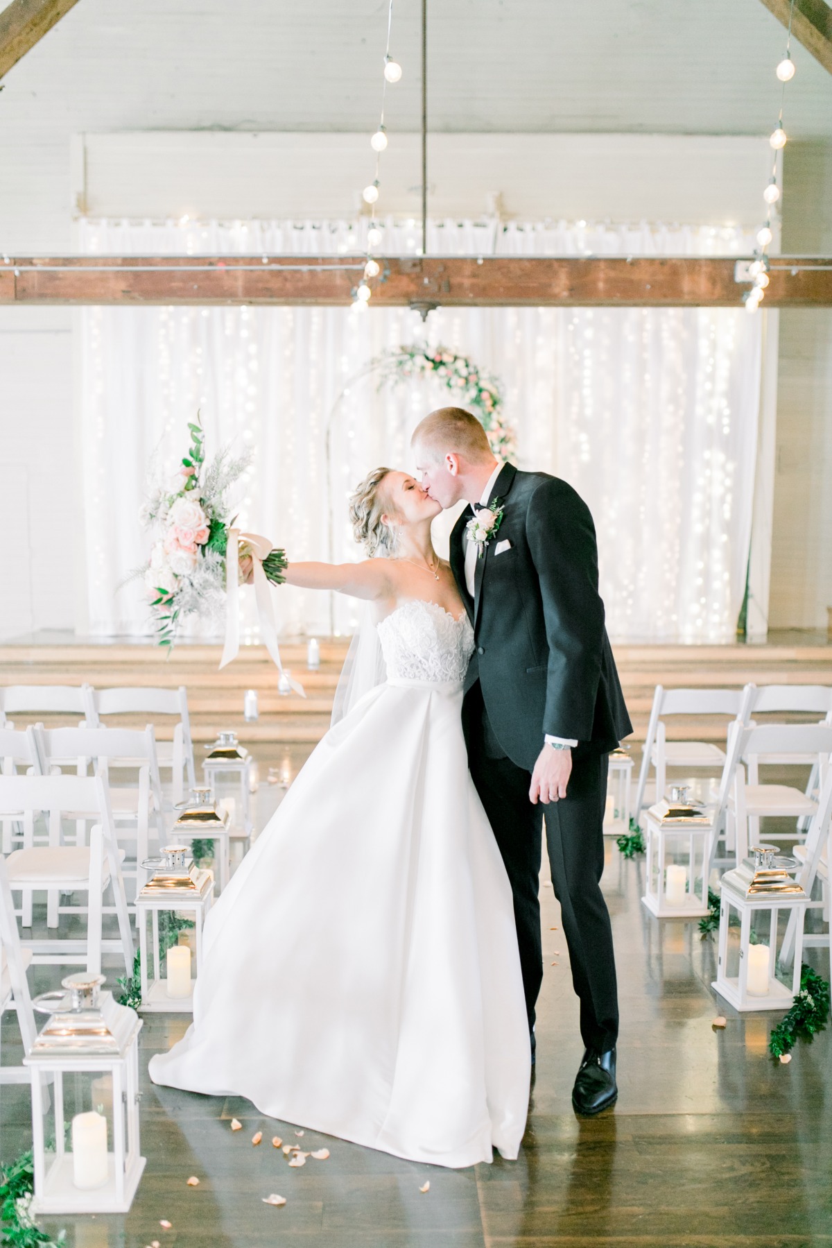 Bride and groom share loving wedding kiss at ceremony