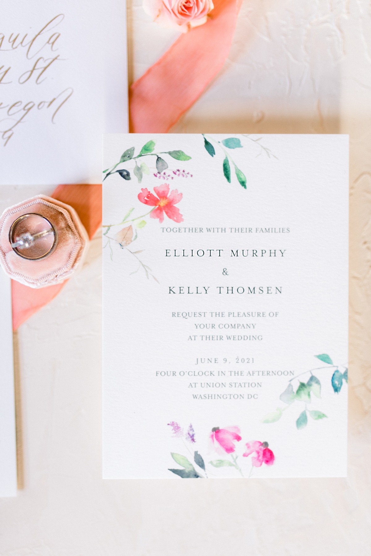 Elegant floral wedding invitation with ring and ribbon detail
