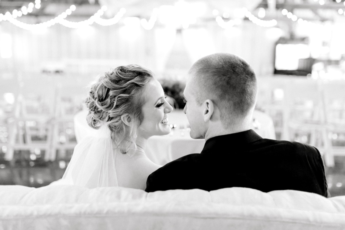 Bride and groom smiling at each other on wedding day