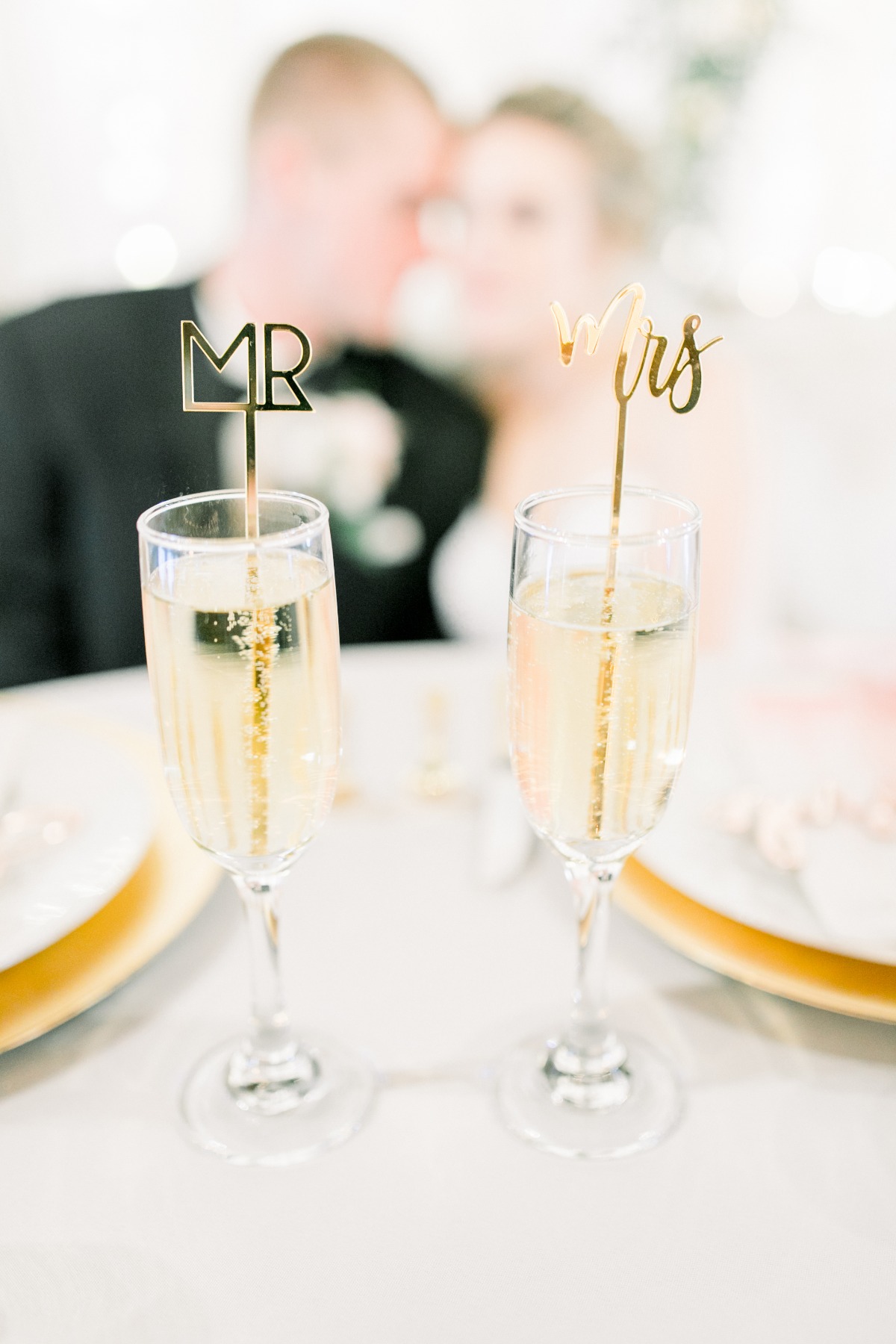 Champagne glasses with Mr and Mrs signs at a wedding reception