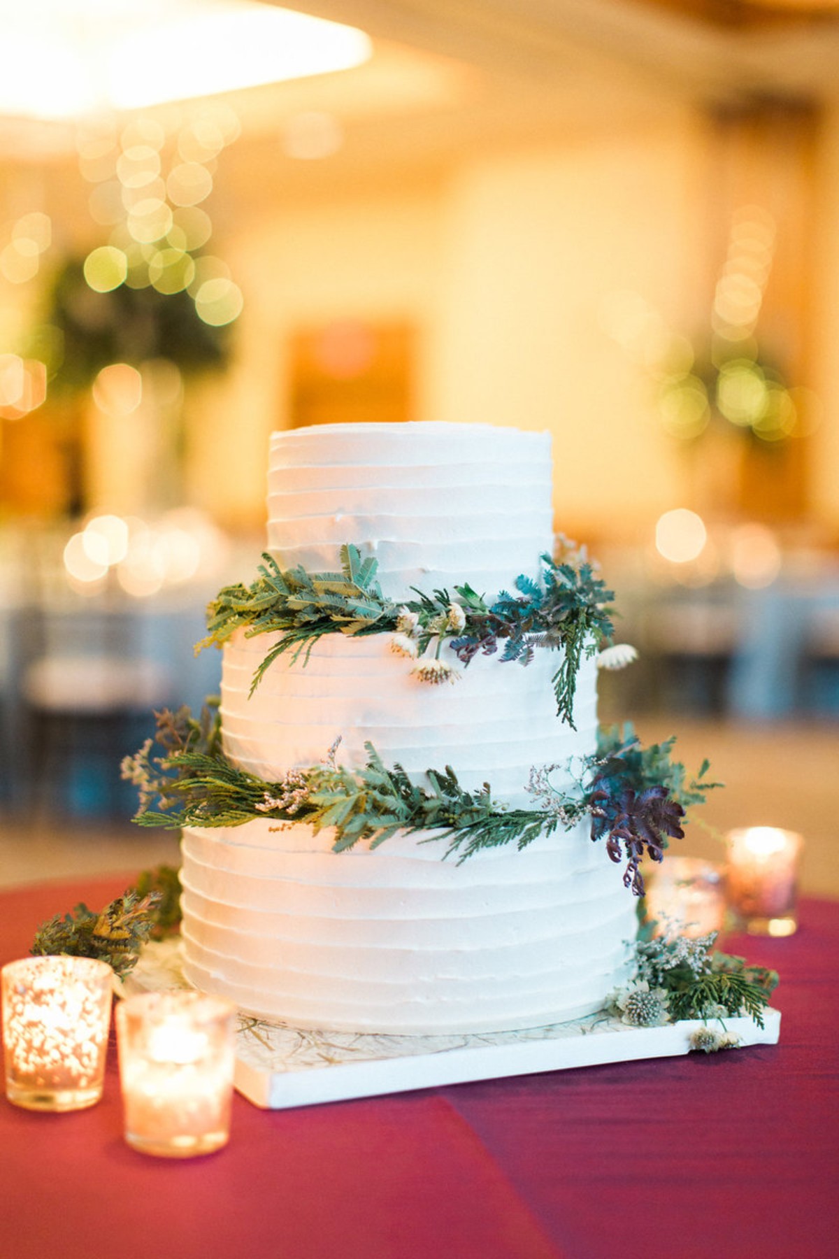 White wedding cake with greenery