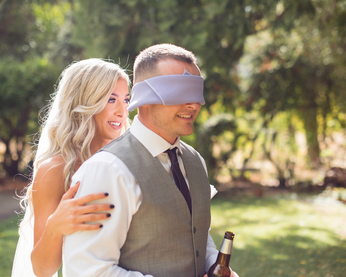 bride and her blindfolded groom