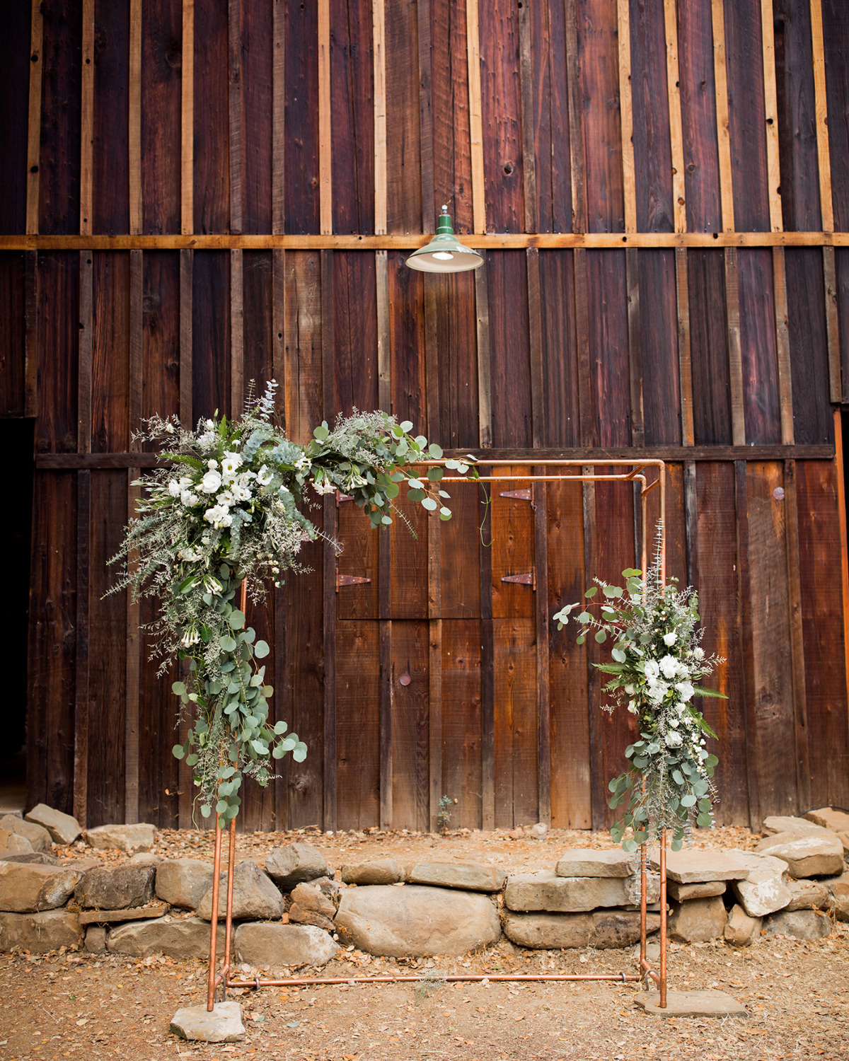 modern copper pipe and floral wedding arch