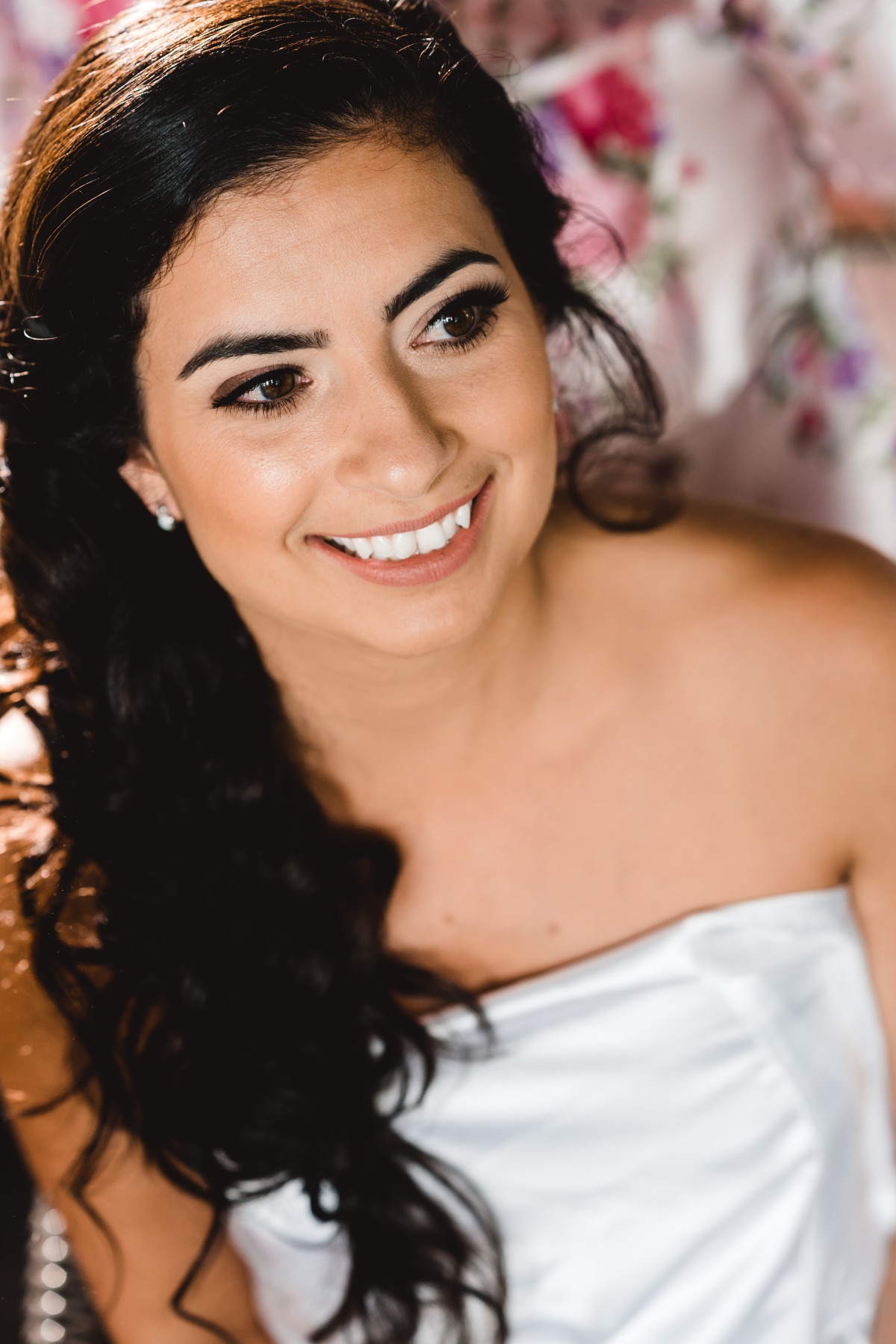 Brunette bride with perfect makeup smiling serenely