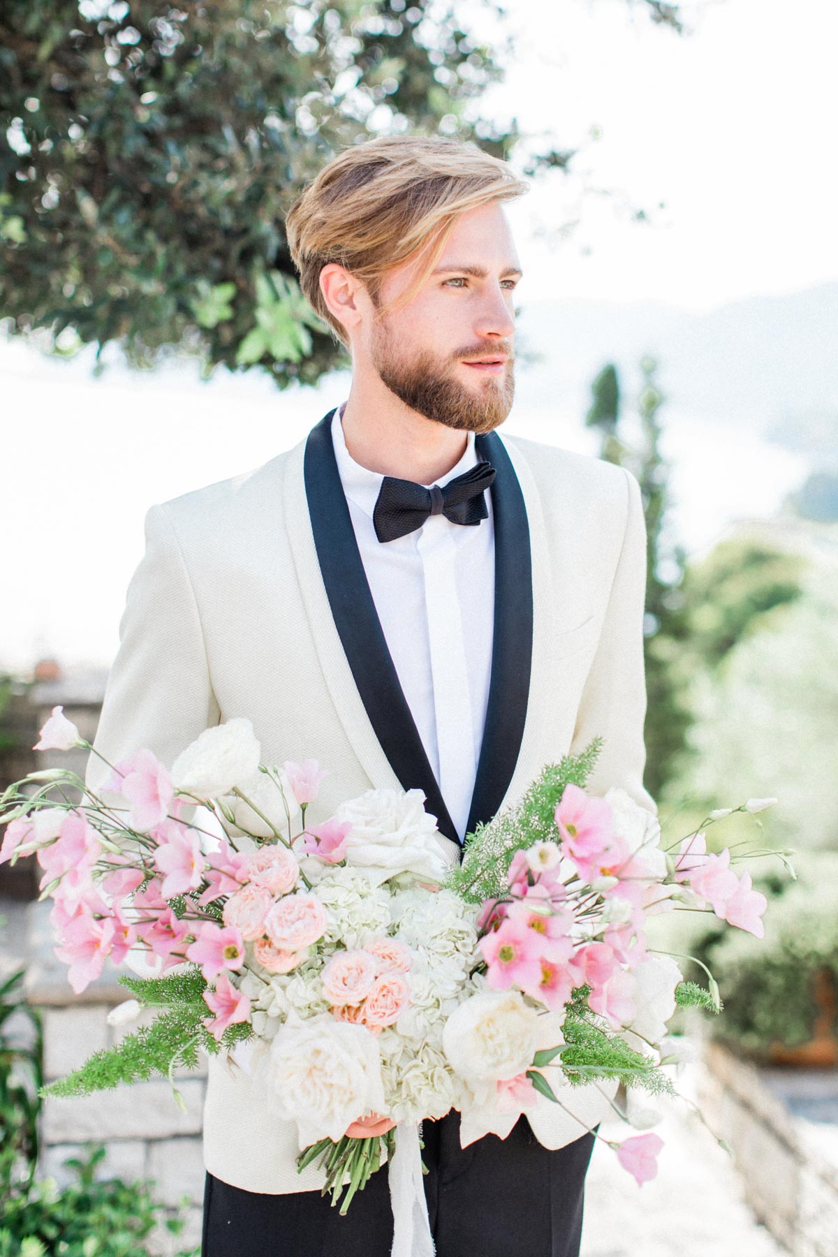 groom in white dinner jacket and black bow tie