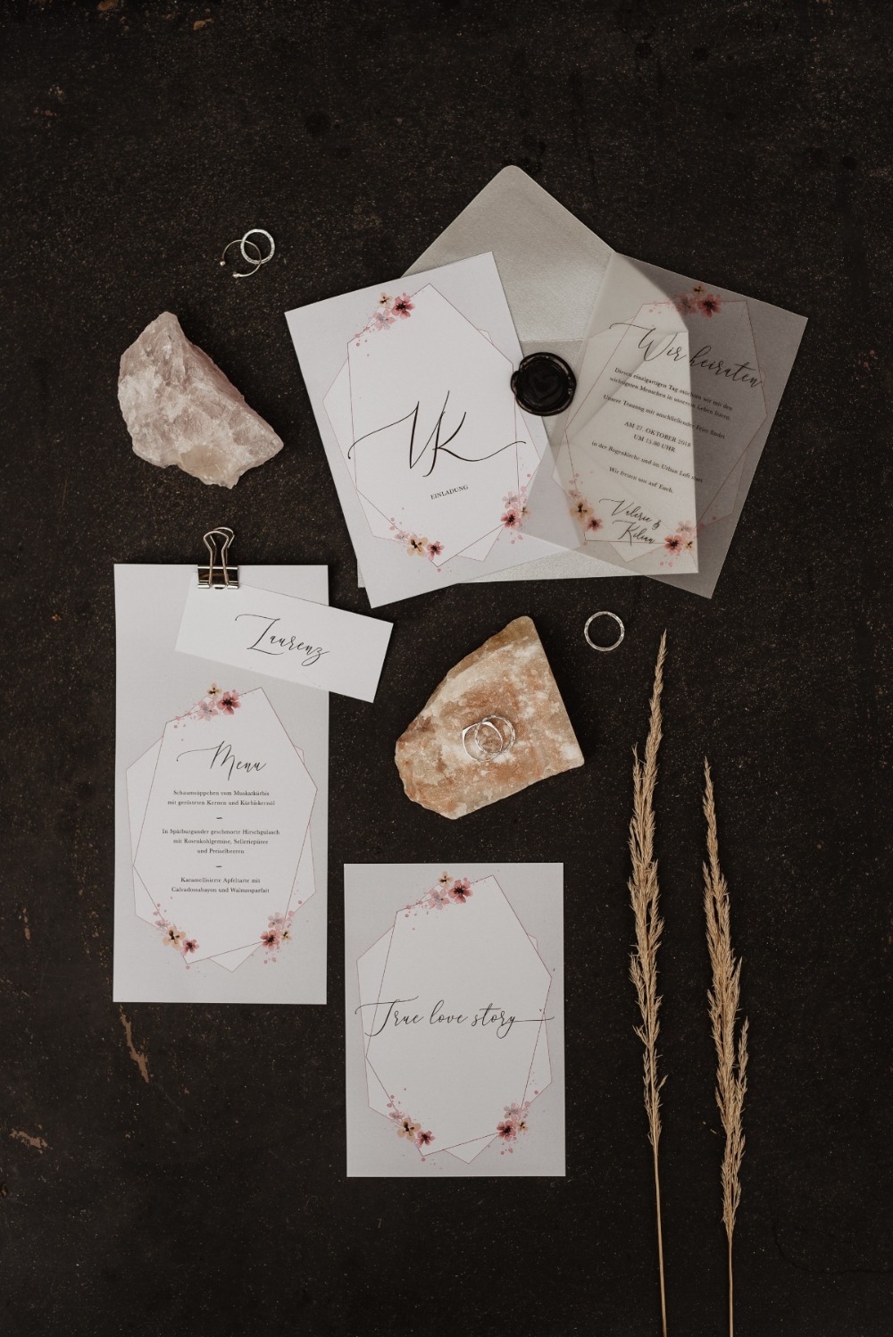 Wedding invitation stationery with floral details and rings