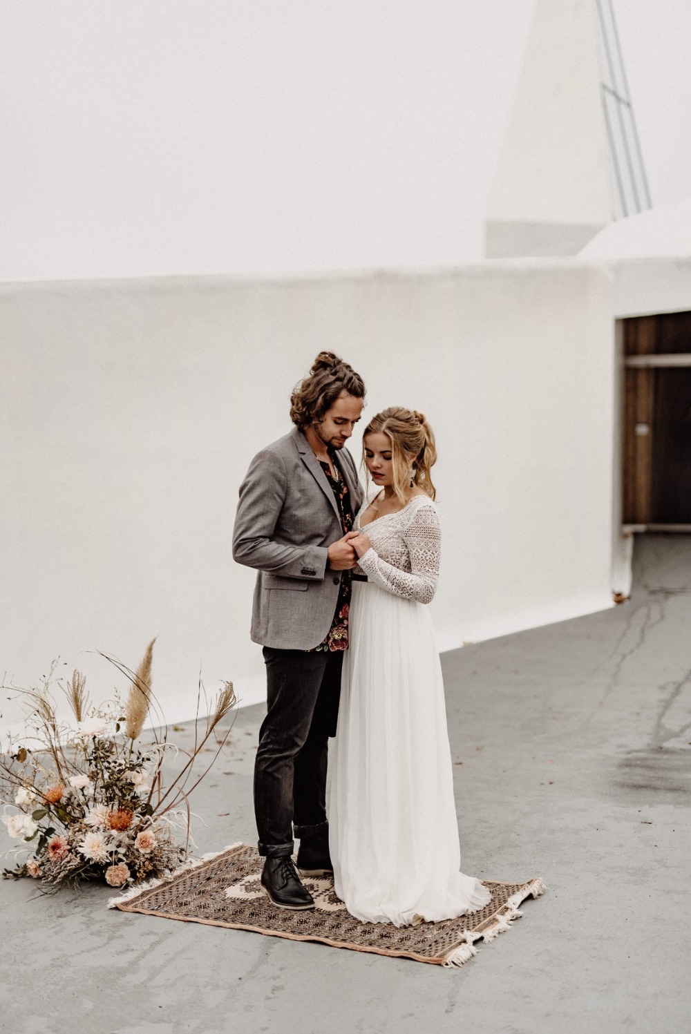 Wedding couple holding hands during their outdoor ceremony